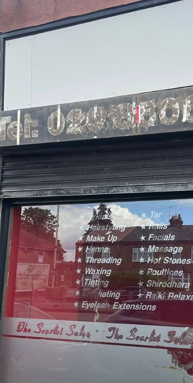 Before: a painted-out fascia, applied vinyl lettering and a red vinyl shop window.